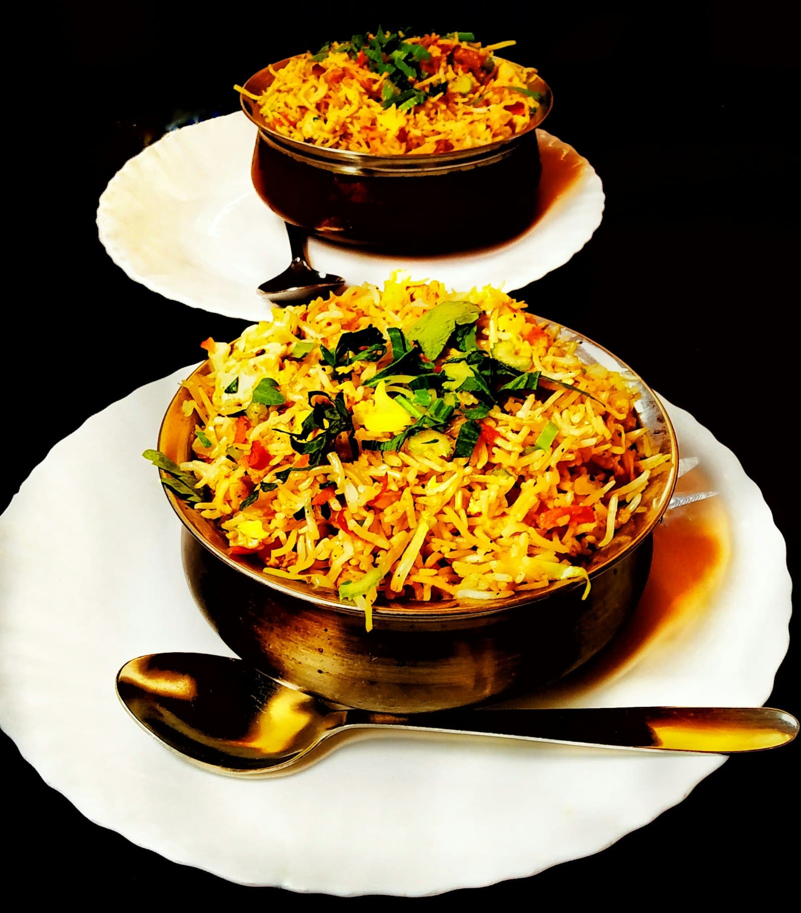 Seasoned rice with herbs in brass bowls